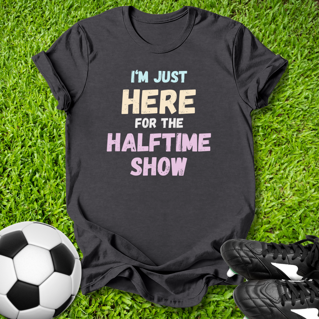 Black t-shirt with humorous text on grass with soccer ball and shoes