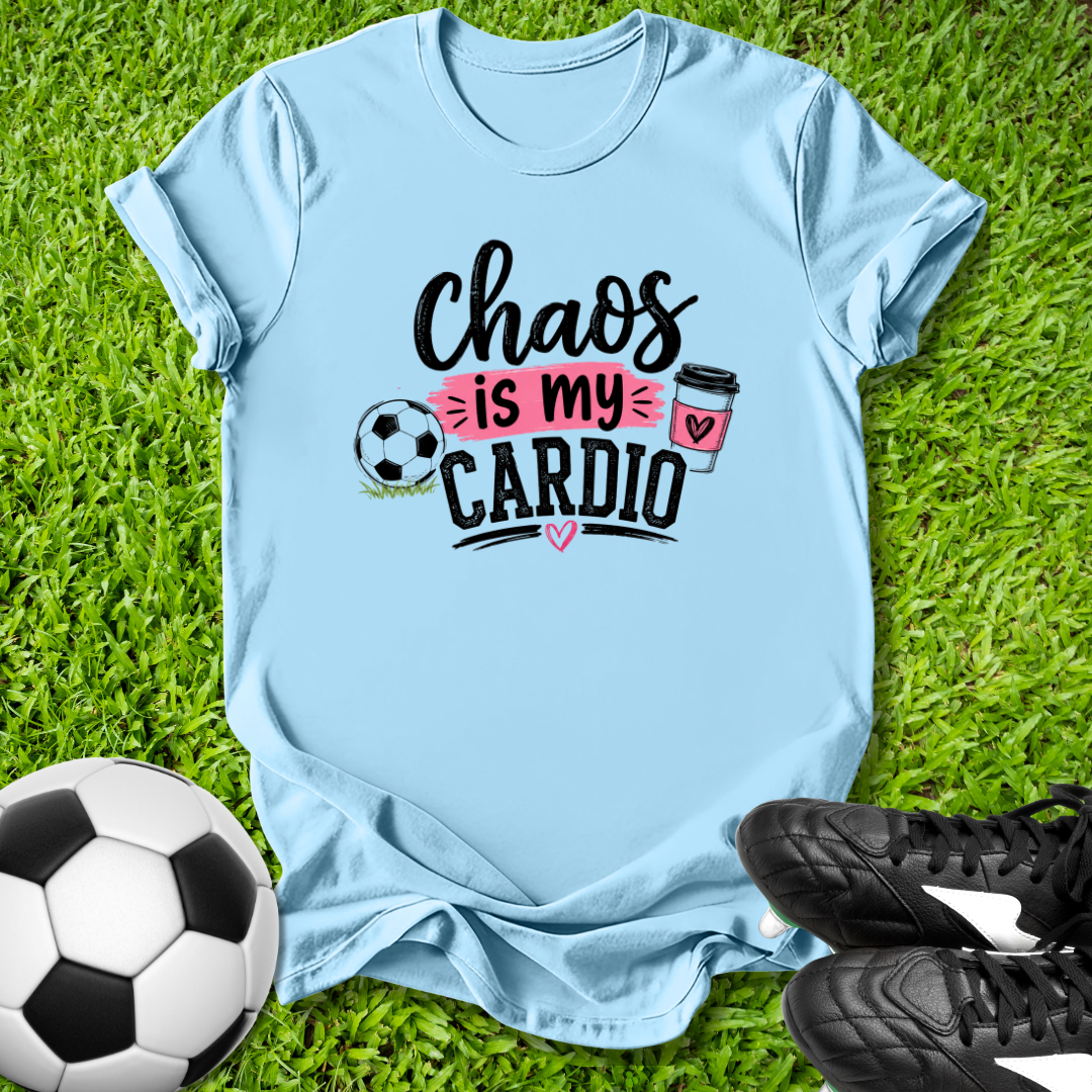 Light blue t-shirt with 'Chaos is my Cardio' text on grass with soccer ball and shoes.