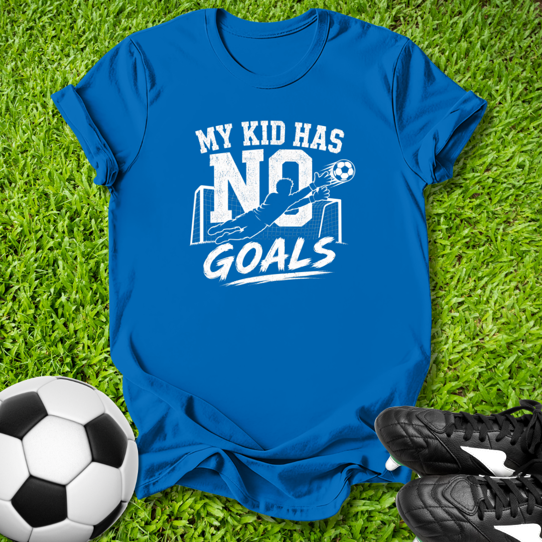 Blue t-shirt with 'My kid has no goals' text on grass with soccer ball and shoes