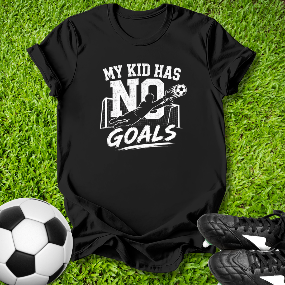 Black t-shirt with 'My kid has no goals' text on grass with soccer ball and shoes