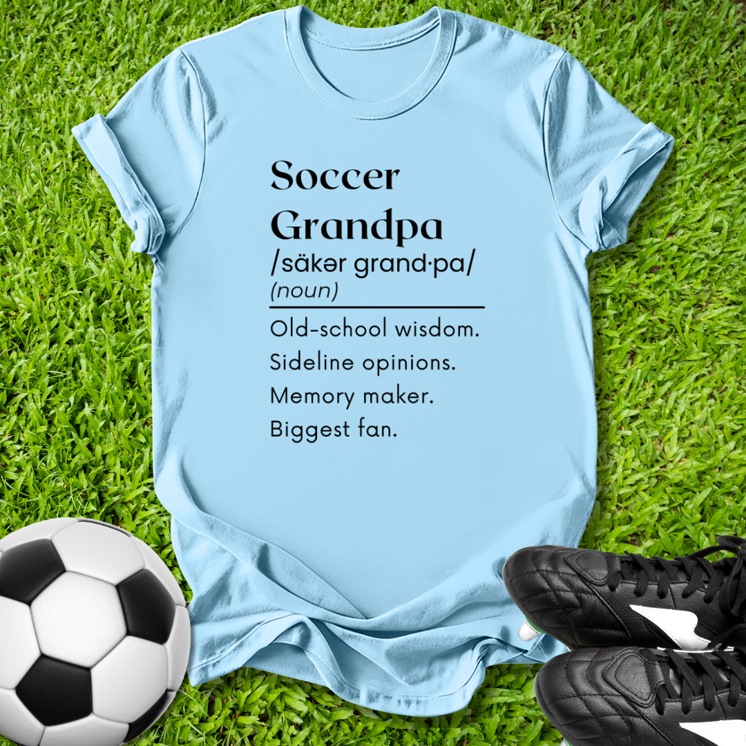 Light blue t-shirt with 'Soccer Grandpa' definition on grass with soccer ball and shoes