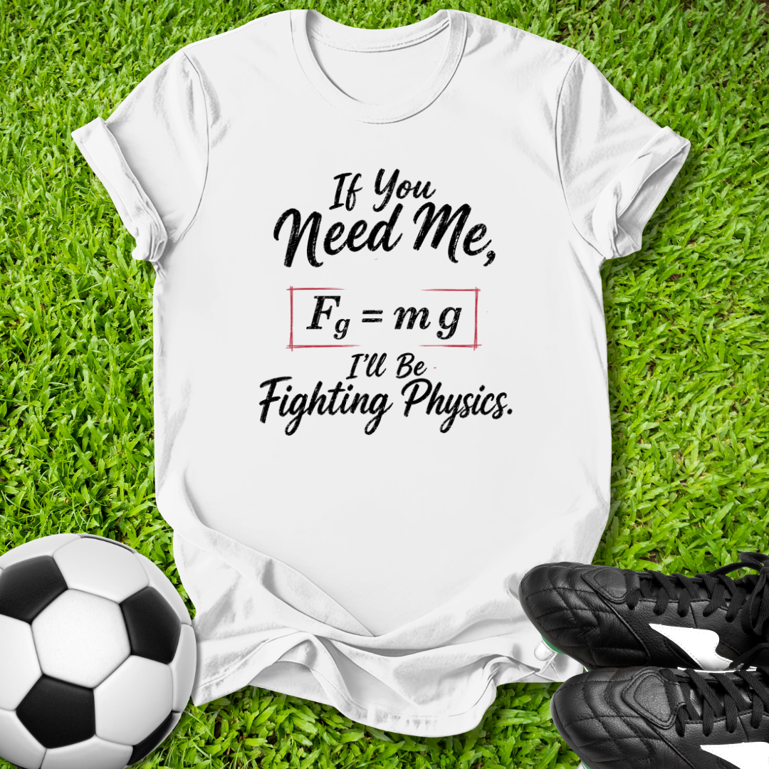 White t-shirt with a humorous physics joke on grass with soccer ball and shoes