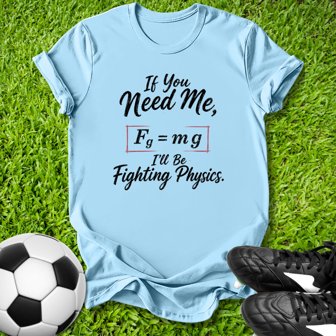 Light blue t-shirt with a humorous physics quote on grass with soccer ball and shoes.