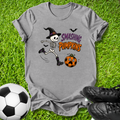 A heather gray graphic t-shirt featuring a cartoon skeleton kicking a pumpkin with the text 'SMASHING PUMPKINS', styled on green grass with a soccer ball and black cleats.